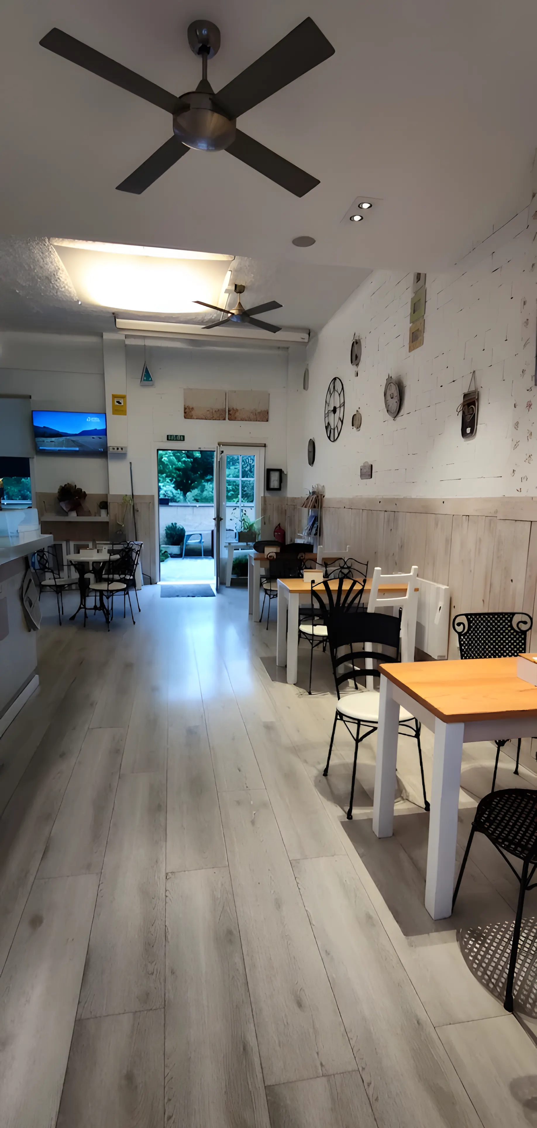 Main room of Goxune coffee shop with wooden floor and tables